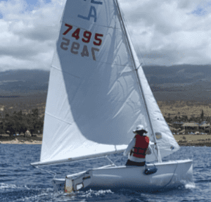 A Kayak With a White Color Sail on Water